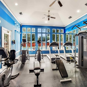 A fresh, bright fitness center with treadmills, eliptical, bicycle and cybex machine