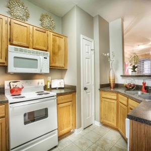 Kitchen of 2 bedroom model home with white appliances