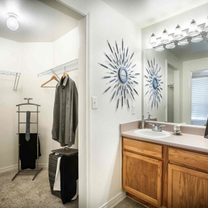 Single vanity bathroom with large walk-in closet